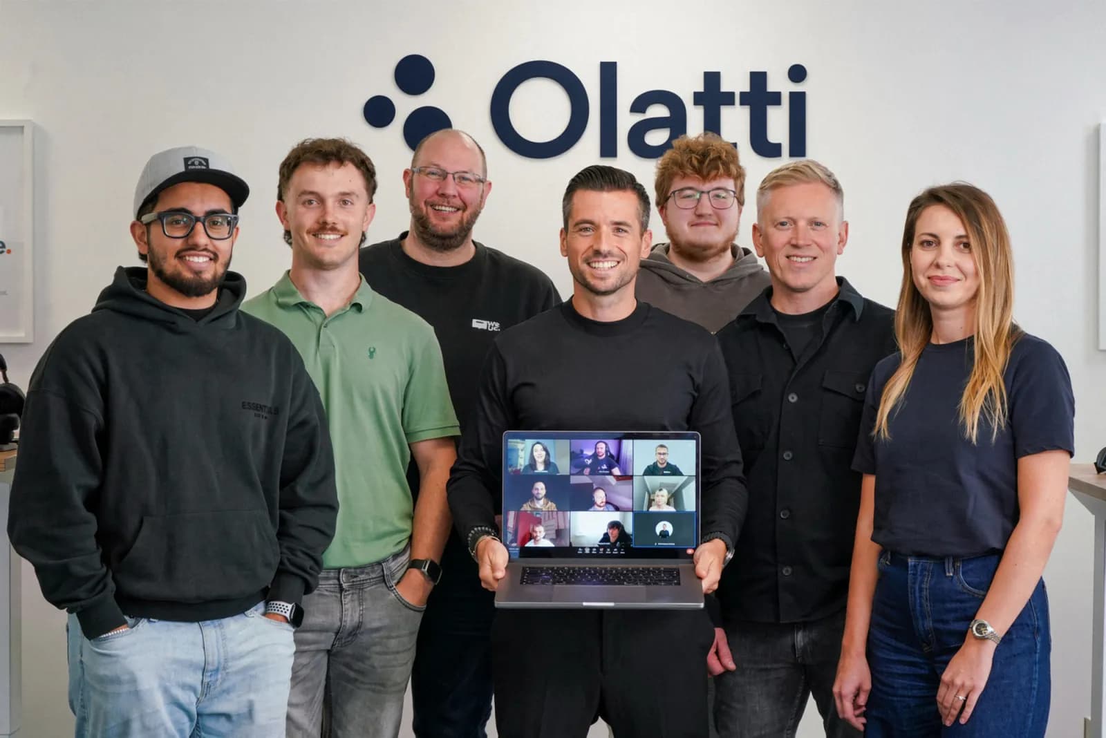 The We UC team in the Southampton office, with remote colleagues joining on a laptop.